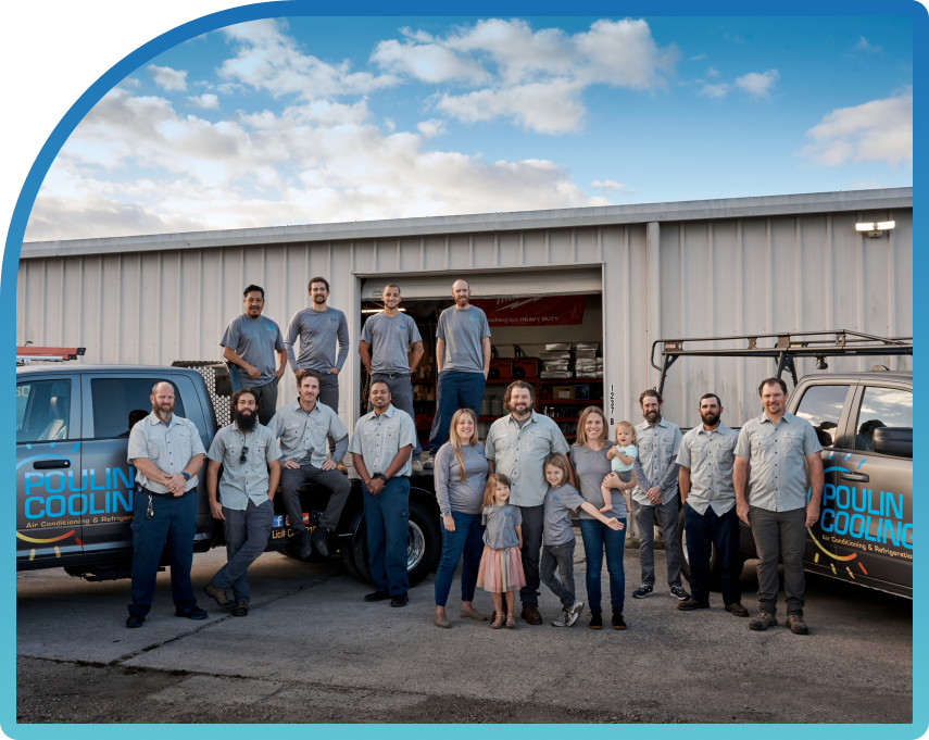 A team of Poulin Cooling employees stand in front of two work vans with the Poulin family in the center