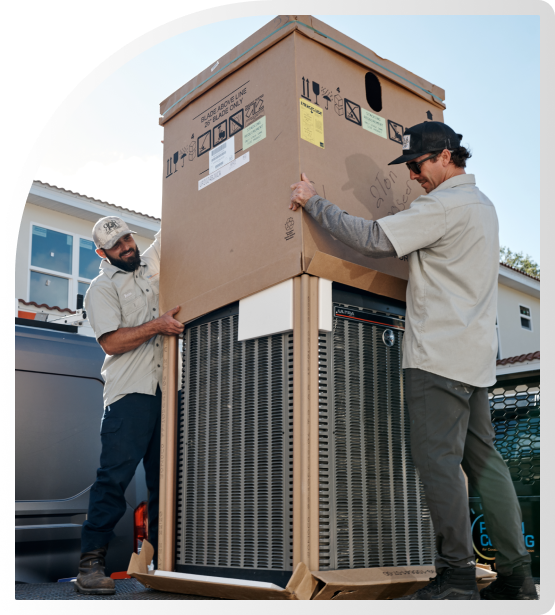 2 Workers unboxing an AC Unit